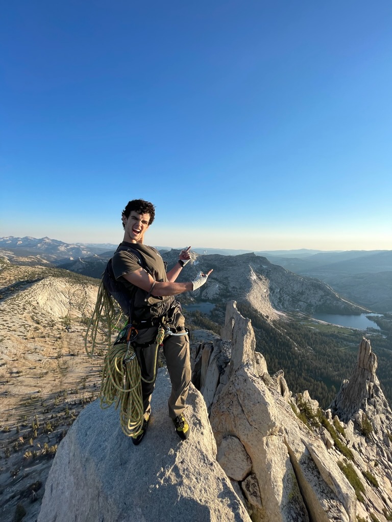 Travis posing on top of Cathedral Peak in Yosemite National Park
